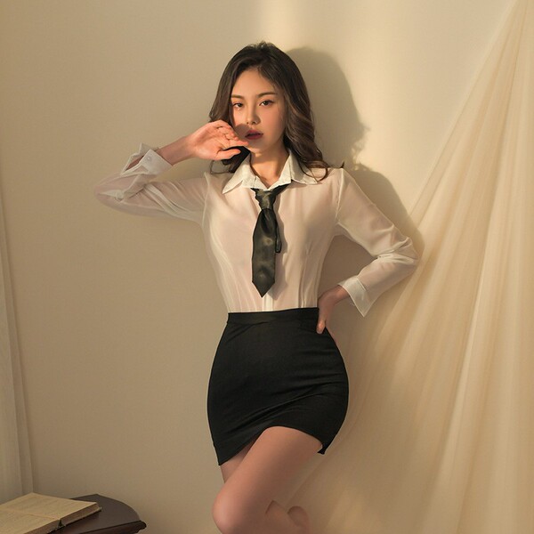 Woman modeling white blouse, black tie, and high-waisted pencil skirt from seductive secretary costume set.