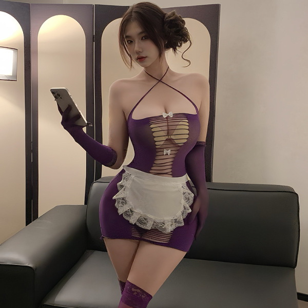 Woman in purple sheer mesh maid costume with white apron, holding phone on black couch.