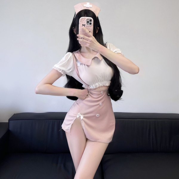 Woman modeling pink nurse-inspired lingerie set with sheer lace halter top and matching skirt, perfect for role play or date ...