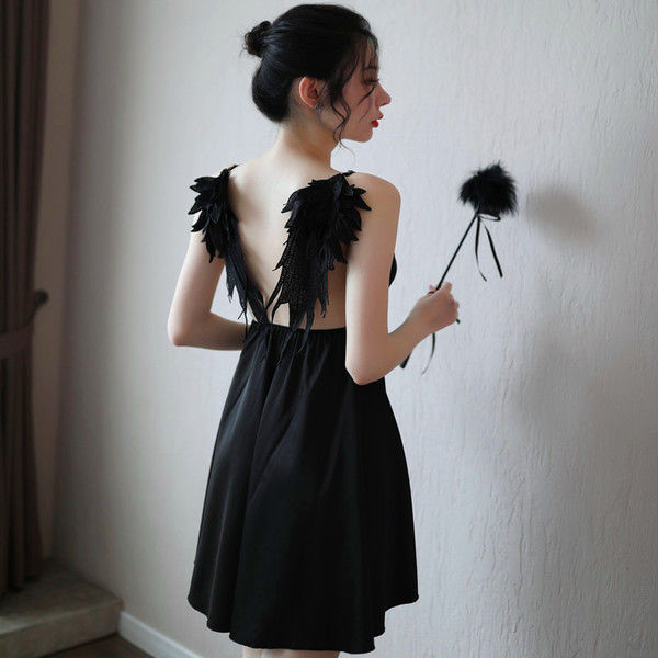 A woman models a black suoqing sensual lingerie set, featuring a strapless design with feathered wings on the back, perfect f...