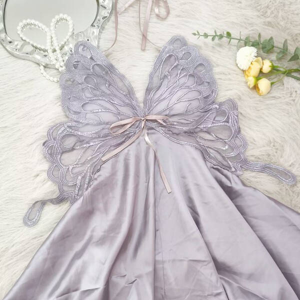 Womens summer ice silk sleep dress with bow & backless cutout - sexy lounge set displayed on a soft surface with decorative f...