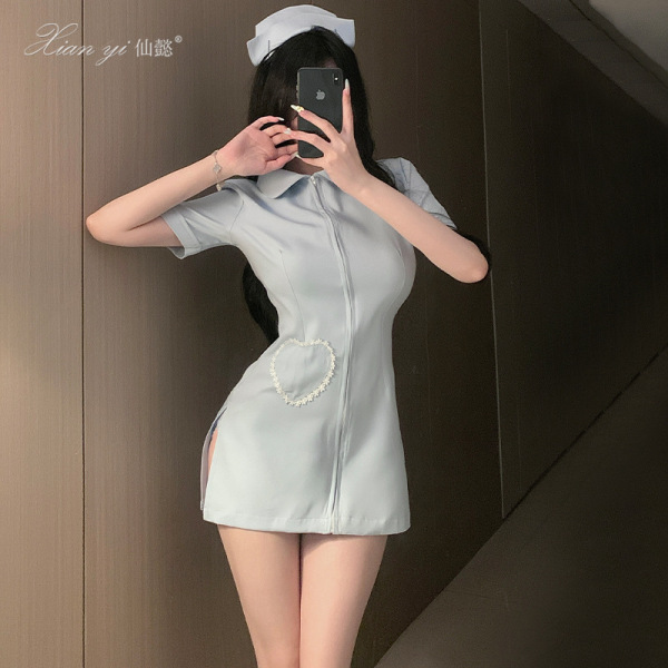 Woman in light blue xianyi sexy nurse costume with heart detail, short dress and cap, posing for mirror selfie.