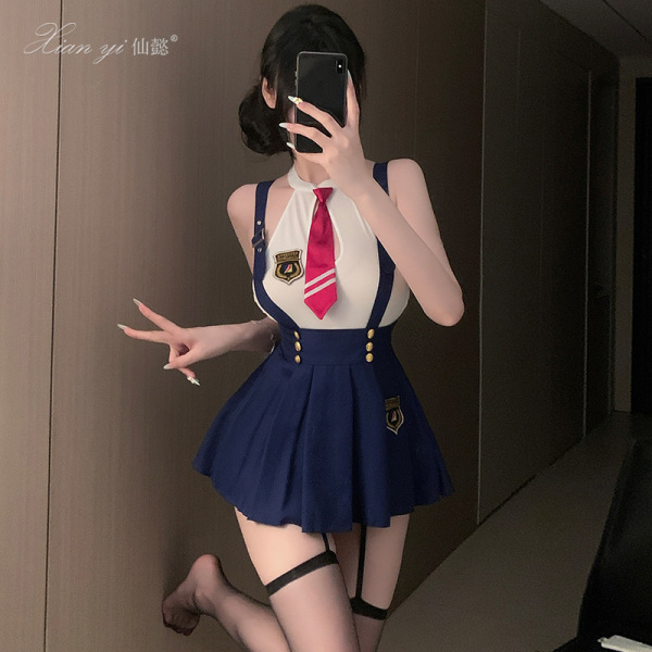 Woman in xianyi womens high-end restrained-luxe lingerie set, featuring a navy skirt and white top with red tie, posing indoo...