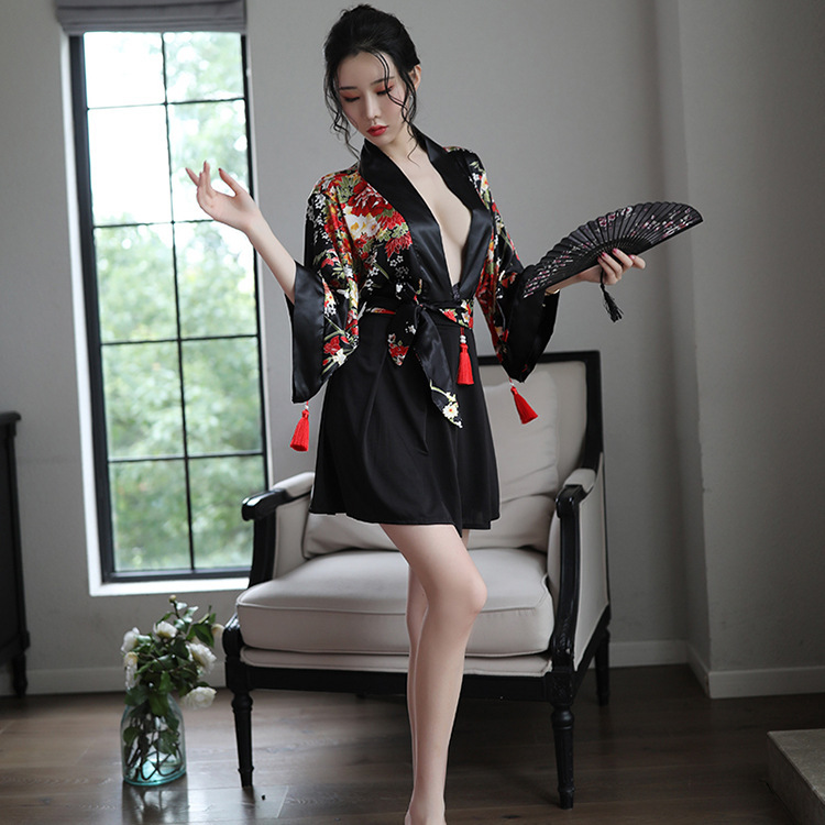 A woman poses elegantly in a black japanese anime-inspired sheer kimono-style sleepwear set, featuring floral patterns and cu...