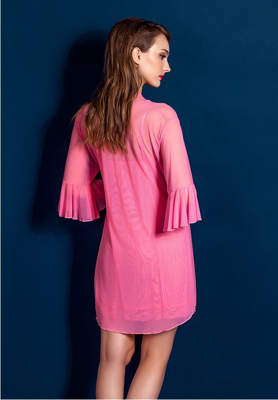 A woman wears a vibrant pink transparent lace robe with ruffled sleeves, exuding elegance and style.