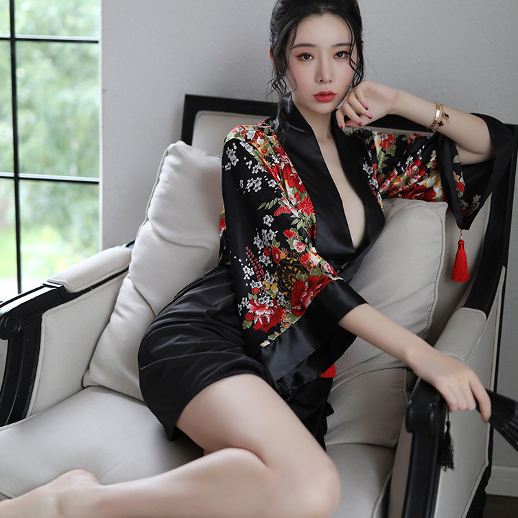 A woman poses elegantly in a black japanese anime-themed sheer kimono-inspired sleepwear set, featuring vibrant floral patter...