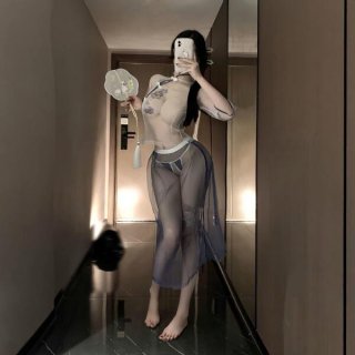 Woman wearing sheer mesh vintage chinese-inspired lace cheongsam lingerie set, holding a fan in a hallway.