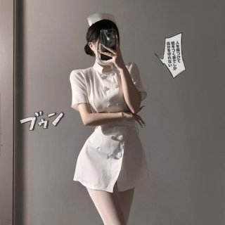 Woman in white sexy nurse costume lingerie set with bow-tie skirt and round neck top, posing seductively.