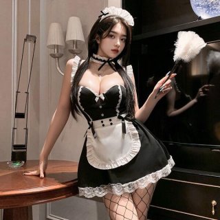 A woman poses elegantly in a black and white maid costume, featuring lace details and a fluffy feather accessory. the outfit ...