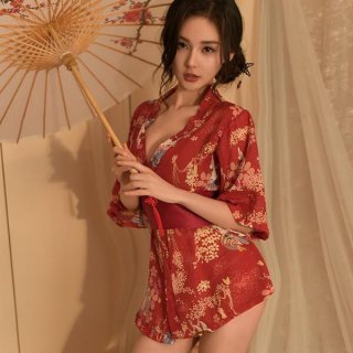 A woman elegantly poses holding a traditional parasol, wearing a vibrant red japanese-style bathrobe adorned with intricate f...