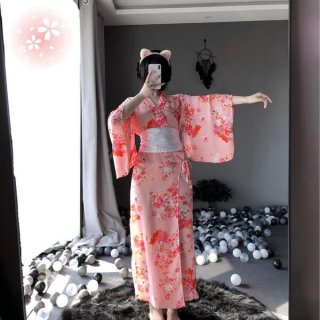 A woman poses in a mirror wearing a pink floral japanese kimono-style cat lingerie set, featuring long sheer satin sleepwear ...