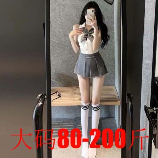 Woman in mirror wearing backless jk-style bodysuit with bow, pleated skirt, and striped knee-high socks.