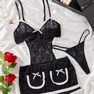 Black lace maid cosplay lingerie set with white trim, bows, and matching thong, styled on satin with roses.