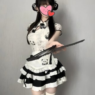 A woman wears a cute panda-themed domoira chinese-style maid outfit, featuring a black and white dress with ruffles and a fan...
