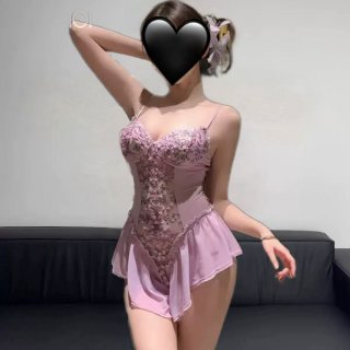 Woman wearing pink floral lingerie sleepwear set with lace trim, sheer mesh panels, and push-up bodysuit design.