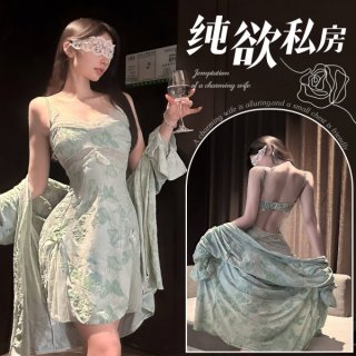 Woman in elegant green lace print chemise with garter belt, holding wine glass, showcasing seductive silk-feel lingerie set.