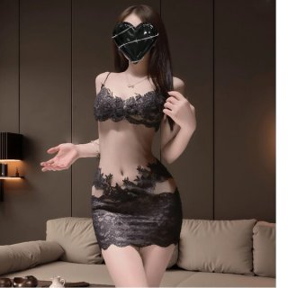 Woman wearing black lace sheer bodycon nightdress set with embroidered mesh babydoll lounge design, posing in a modern bedroo...