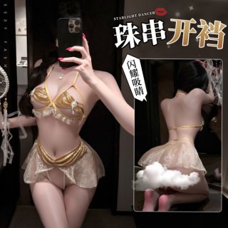 Woman modeling gold manyan starlight dancer lingerie set featuring pearl details and open-crotch design.