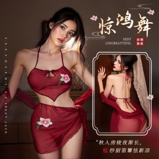 A woman models a red halter bodysuit set with floral embroidery, designed for sensual allure and dance inspiration.