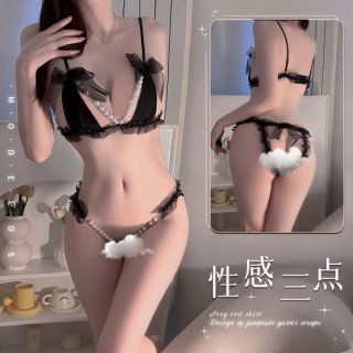 Woman modeling black lace pearl temptation thong lingerie set with pearl details and bow accents, featuring push-up bra and m...
