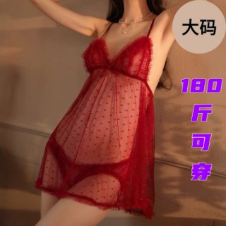 Woman wearing red plus size lingerie sleep set with sheer polka dot fabric and feather trim, perfect for date nights.