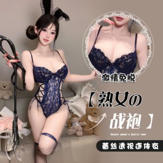 Woman wearing a navy blue lace bunny bodysuit with floral trim and open chest design, holding a whip.