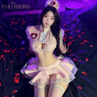 Woman in pure temptation nurse costume with lace lingerie and flirty petticoat skirt, posing on bed with rose petals.