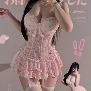 Woman wearing pink sensual lace cake dress lingerie with push-up corset, ruffled skirt, and white thigh-high stockings.