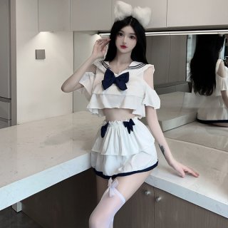 A stylish outfit featuring a sailor-themed top with ruffles and a large bow, paired with a pleated mini skirt and matching ac...
