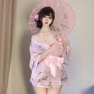 A woman elegantly poses holding a delicate pink parasol, wearing a sweet and seductive yukata robe adorned with floral prints...
