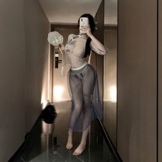 Woman wearing sheer mesh vintage chinese-inspired lace cheongsam lingerie set, holding a fan in a hallway.