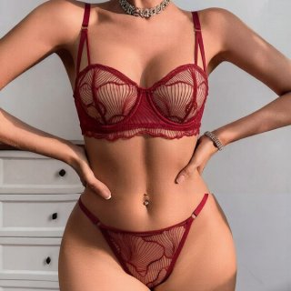Woman modeling wine red plus size lingerie set with sheer mesh, lace cutouts, and delicate straps.