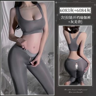Woman modeling gray open-crotch yoga pants and matching sports bra, showcasing seductive fitness lingerie set for outdoor wea...