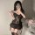 Woman modeling black lace corset lingerie set with garters, minimalist sexy sleepwear for women.