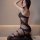 Woman wearing qingyege sheer black bodysuit with open-crotch design and matching stockings, elegant lingerie set.