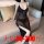 Woman wearing plus size deep v-neck sheer mesh nightgown, sitting on sofa. elegant black lingerie for women up to 200 lbs.