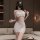 Woman wearing white lace sheer bodycon nightdress set with embroidered mesh babydoll design in modern living room.
