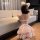 Girl in pink domila maid lingerie set with fluffy ears, posing by sofa.