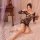 Woman wearing qingyege bold striped mesh bodycon lingerie with cut-out details, posing on bed in cozy bedroom setting.