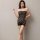 Woman wearing black plus size sexy lace fishnet bodystocking with tear-away sheer mesh design.