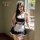 Woman modeling black and white french maid lingerie set with lace trim, apron, headpiece, and choker by window.