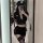 Woman in suoqing police uniform lingerie set with short skirt, crop top, and hat, posing for mirror selfie.