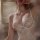 Woman wearing white lace sleep dress with push-up wire-free cami, body-conscious fit, and elegant trim for small bust.