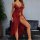 Woman wearing a red sheer lace sleep dress with delicate straps and a flowing silhouette, posing elegantly beside a black sof...