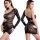 Curvy woman modeling a black rhinestone mesh bodysuit with long sleeves, cutouts, and an open back.
