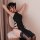 A woman poses elegantly in a black 1945-inspired sexy role play lingerie set featuring high-slit long dress sleepwear with re...