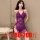 Woman modeling a purple plus size lace bodysuit with sheer mesh, cut-outs, and adjustable ties, designed for a busty fit up t...