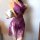 Woman wearing purple lace bodysuit with sheer mesh, cut-outs, and adjustable ties; holds white mug; fits up to 200 lbs.