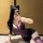 Woman in purple lace lingerie set with cat ears, posing for mirror selfie.