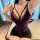 Curvy woman modeling purple midnight lace lingerie set with thin straps, deep v-neck bra and matching panties, designed for s...